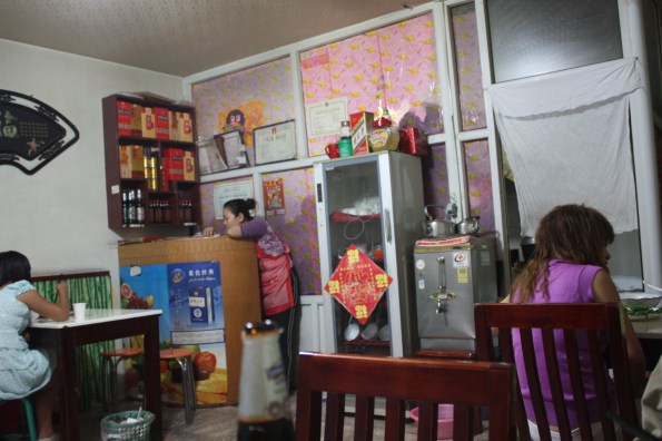 A busy hole-in-the-wall. The thing that looks like a fridge is where they store the clean" dishes. 