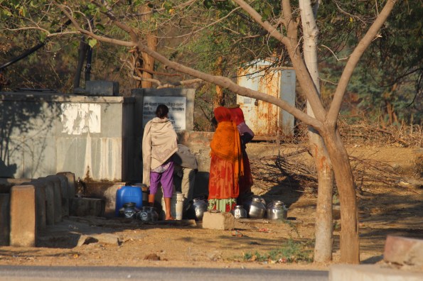 collecting water, India