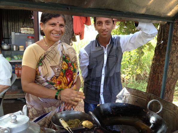 Indian mother and son with food stall