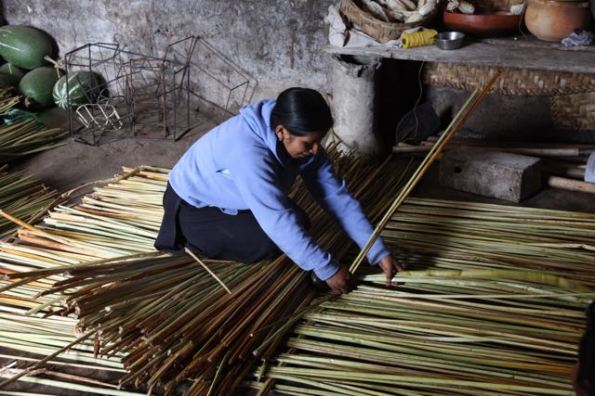 Weaving a mat, Ecuador