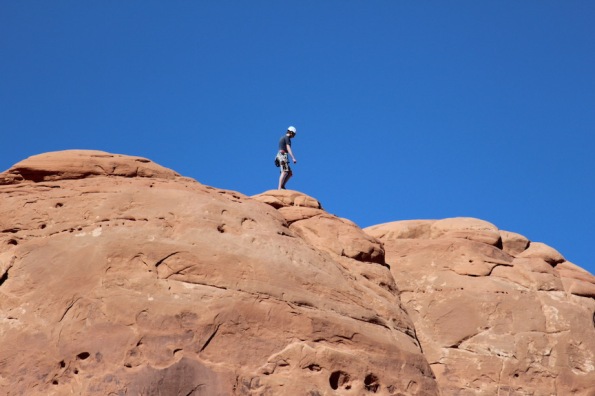 A climber on the rock beside the Balanced Rock