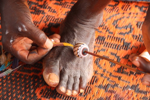 Painting a bead in the Ivory Coast
